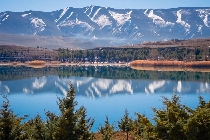 Tranquil Lake Tislit with mountains in the background